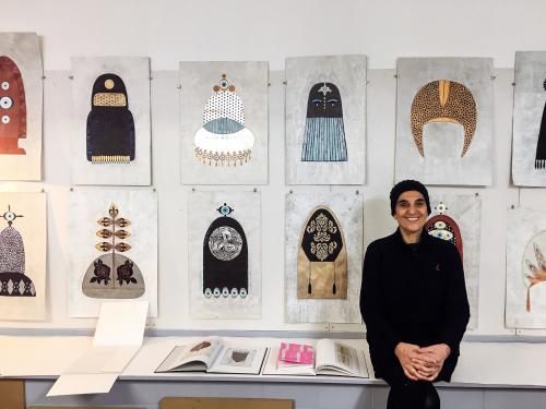 Cholud Kassem vor einer Bilderreihe zum Ausstellungsthema. Cholud Kassem vor ihren Bildern in einer Ausstellung.